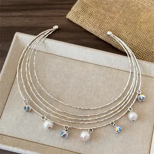 Detail view of multi-layer silver choker with pearls and iridescent crystal charms.