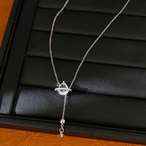Élégant collier en zircon larme de saturne argenté présenté sur un plateau à bijoux noir