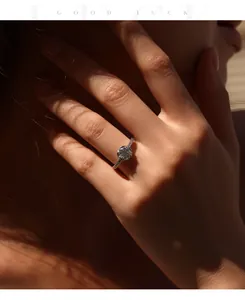 Close-up of 1 carat moissanite solitaire ring in S925 silver on woman's hand