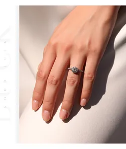 Close-up of sparkling 1 carat moissanite ring on model's hand in silver