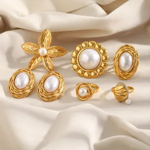 Detailed view of 18K gold plated stainless steel pearl jewelry set with floral rings