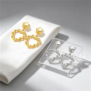 Detailed view of retro geometric pleated hollow heart earrings in gold and silver finish