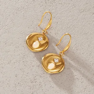 Detailed view of gold stainless steel earrings with natural stone and zircon inlay