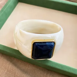 Retro marbled acrylic bangle with square blue center stone detail