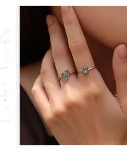Close-up of elegant S925 sterling silver rings set with unique green moss agate stones
