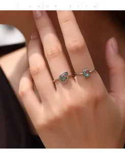 Close-up detail of S925 sterling silver rings featuring synthetic moss agate stones