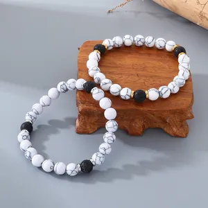Vintage white turquoise and lava stone elastic couple bracelets set on a wooden base