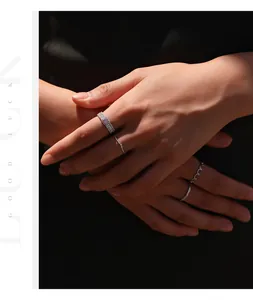 Primer plano de un anillo de moissanita rosa y joyas de plata en manos elegantes