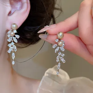 Elegant French style zircon and pearl tassel earrings shown in a detailed close-up view