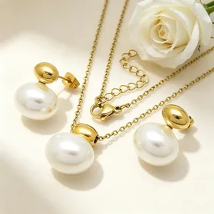 Elegant gold-tone stainless steel jewelry set featuring oval white pearls and studs