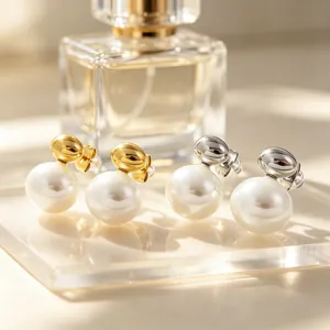 Close-up view of minimalist stainless steel earrings with elegant white shell beads