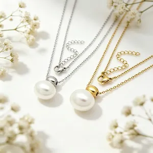 Detail view of minimalist stainless steel necklaces with oval white pearl pendants