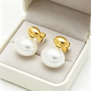 Detailed view of elegant gold-plated stainless steel earrings with white oval pearls