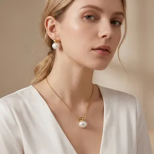 Close-up of minimalist gold-tone pearl necklace and earrings set worn by a model