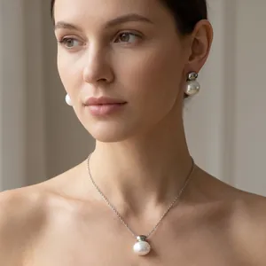 Detailed shot of woman wearing elegant white shell necklace and earring set in silver