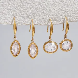 Vue détaillée de boucles d'oreilles en titane doré avec zircons marquise et ronds