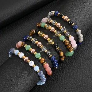 Macro view of 8mm natural stone beaded bracelets with pink crystal and agate accents.