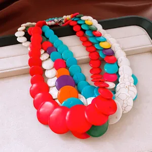 Detail view of a chunky multi-layered necklace with vibrant colorful round stone beads.