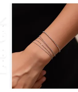 Detailed macro view of S925 silver minimalist thin chain bracelets for stacking