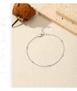 Detailed macro view of a minimalist 925 sterling silver beaded chain bracelet