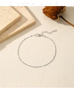 Detailed view of a minimalist S925 silver fine chain bracelet with small polished discs.