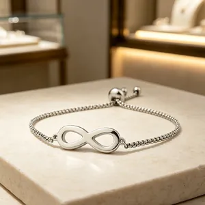 Detail shot of a silver stainless steel infinity symbol bracelet with adjustable box chain