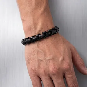 Close-up of a punk-style black stainless steel dragon bone bracelet on a male wrist