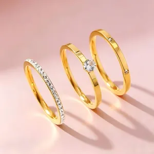 Detailed view of 3-piece gold stainless steel ring set with cubic zirconia stones