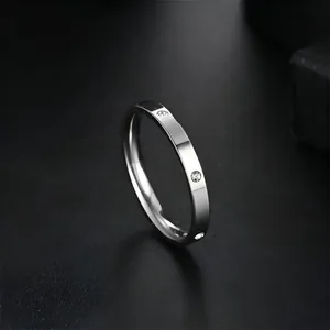 Detailed macro view of a sleek stainless steel ring featuring micro-paved cubic zirconia accents