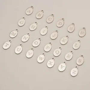 Detailed view of 26 stainless steel oval alphabet charms from A to Z for DIY jewelry