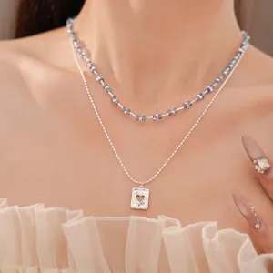 Dubbellaagse kralenketting met een vierkante hart hanger in zilver