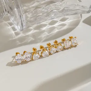 Macro detail of gold plated stainless steel stud earrings with various CZ stone shapes.