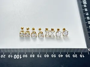 Close-up of assorted stainless steel zircon stud earrings showing multiple stone shapes