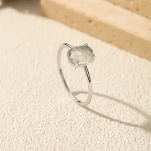 Minimalist S925 sterling silver ring featuring a synthetic moss agate on stone surface