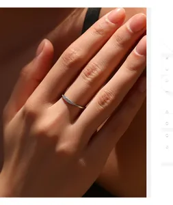 Detailansicht eines eleganten Silberrings mit Moissanit-Steinen an einer Hand.