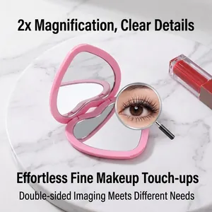 Compact pink heart-shaped portable folding makeup mirror with 2x magnification detail