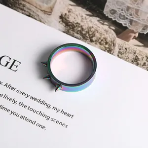 Close-up of rainbow stainless steel ring with three spikes for punk style