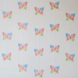 Colorful 3D butterfly paper garland for party room decoration hanging on wall background
