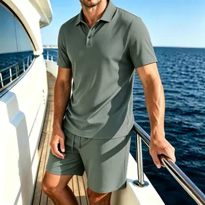 Detail view of men's sage green mesh ice silk polo and shorts set on a boat.