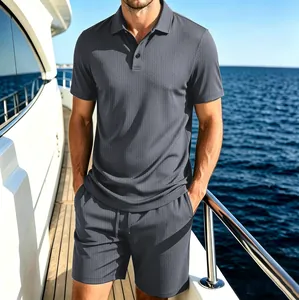 Detailed view of men's dark grey mesh ice silk polo shirt and shorts set on a sunlit yacht deck