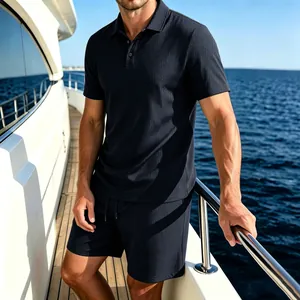 Man wearing navy mesh ice silk polo shirt and shorts set on a luxury yacht deck