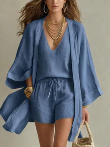 Close-up of blue cotton linen texture on summer three-piece set with cardigan and shorts