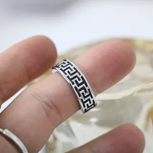 Vintage titanium steel ring for men featuring a classic black Greek key meander pattern