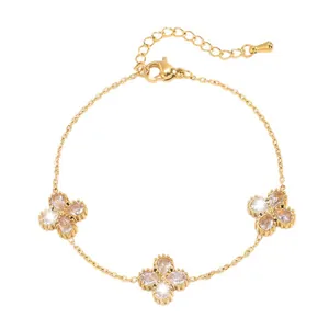 Elegant gold titanium steel bracelet featuring sparkling teardrop crystal four-leaf clovers