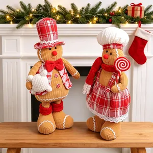 Pair of Christmas gingerbread man telescopic figurines in a festive fireplace setting.