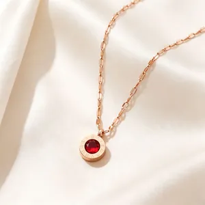 Macro view of rose gold Roman numeral necklace with a red crystal pendant