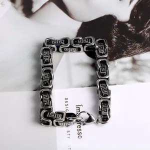 Detailed view of men's titanium steel bracelet with intricate Greek key pattern links