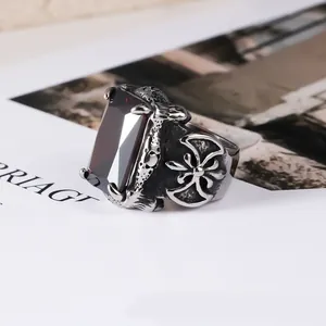 Macro view of men's titanium steel gothic ring with a large red rectangular gemstone