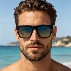 Close-up of man wearing stylish square black sunglasses with gradient lenses on beach