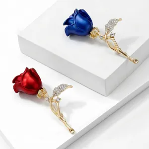 Elegant red and blue rose flower brooches with gold plating and sparkling crystal accents.